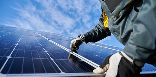 Man installing solar panel installer in Scotland and Alexandria